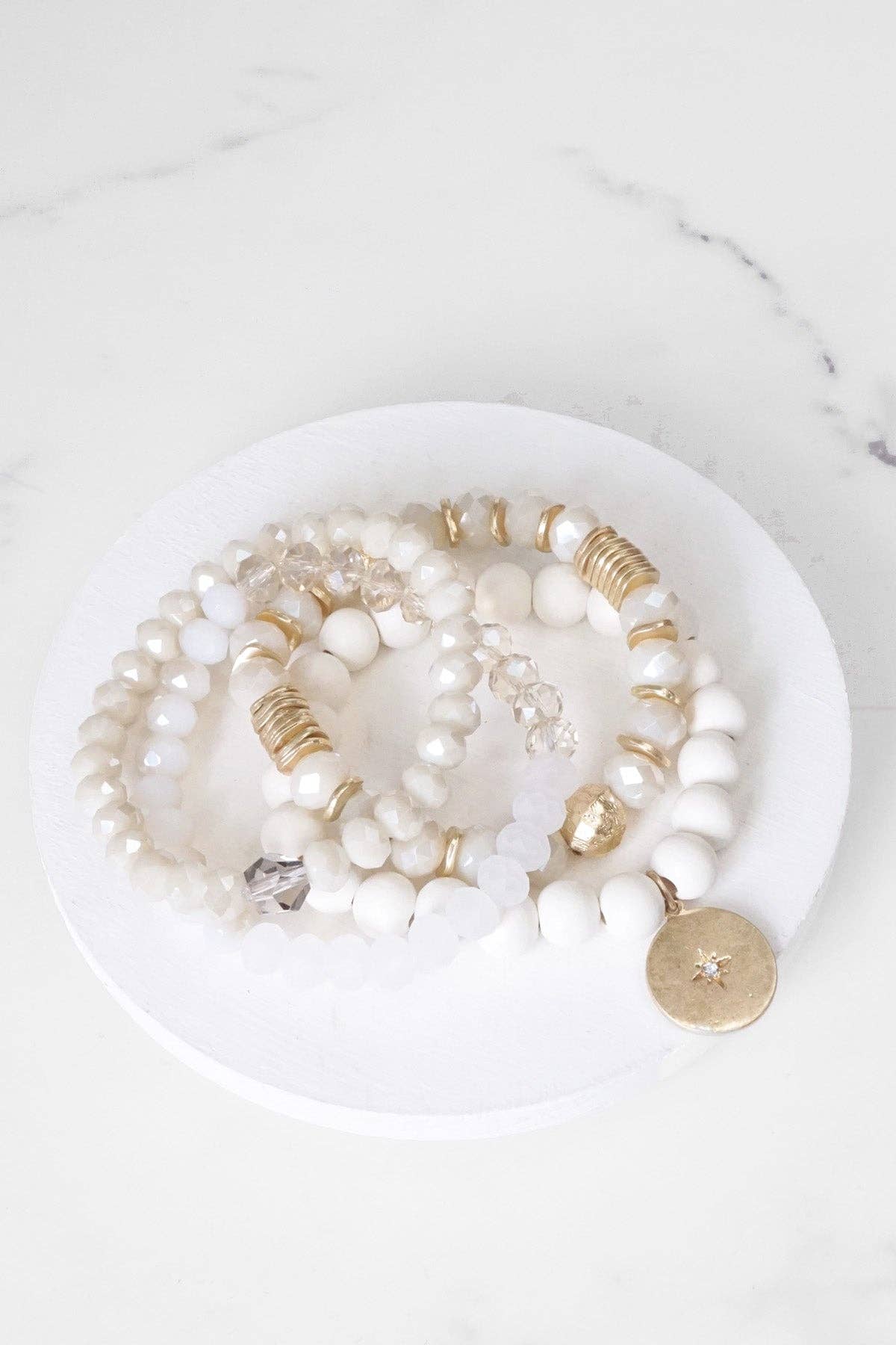 Beaded bracelets set in White Cream with a coin charm