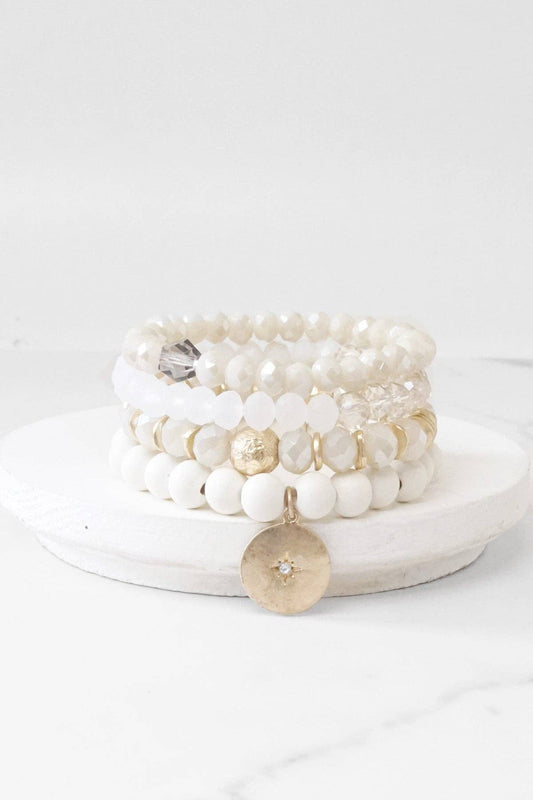 Beaded bracelets set in White Cream with a coin charm